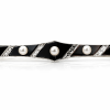 A platinum brooch from 1925 studded with natural pearls and onyx stones