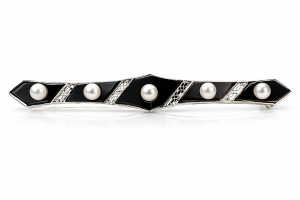 A platinum brooch from 1925 studded with natural pearls and onyx stones